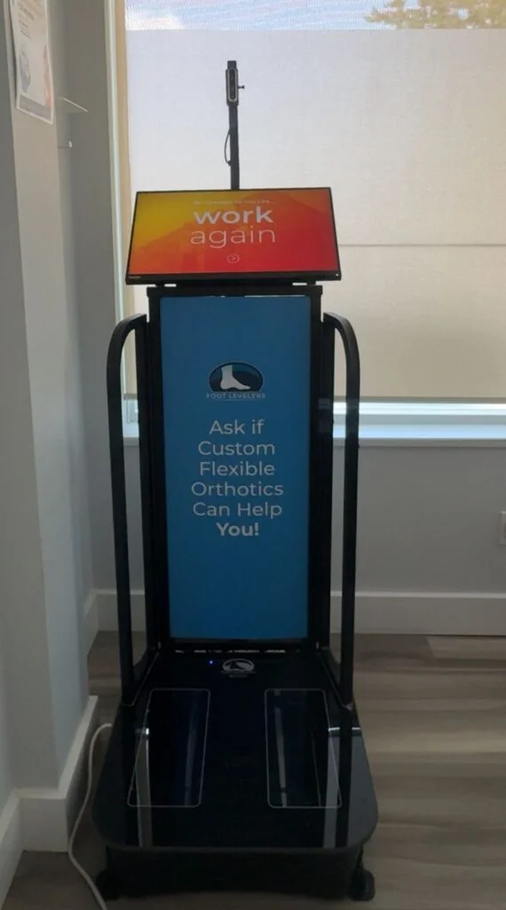 A custom orthotics digital foot scanning machine and kiosk for biomechanical assessment at Belmont Physiotherapy & Health Clinic.