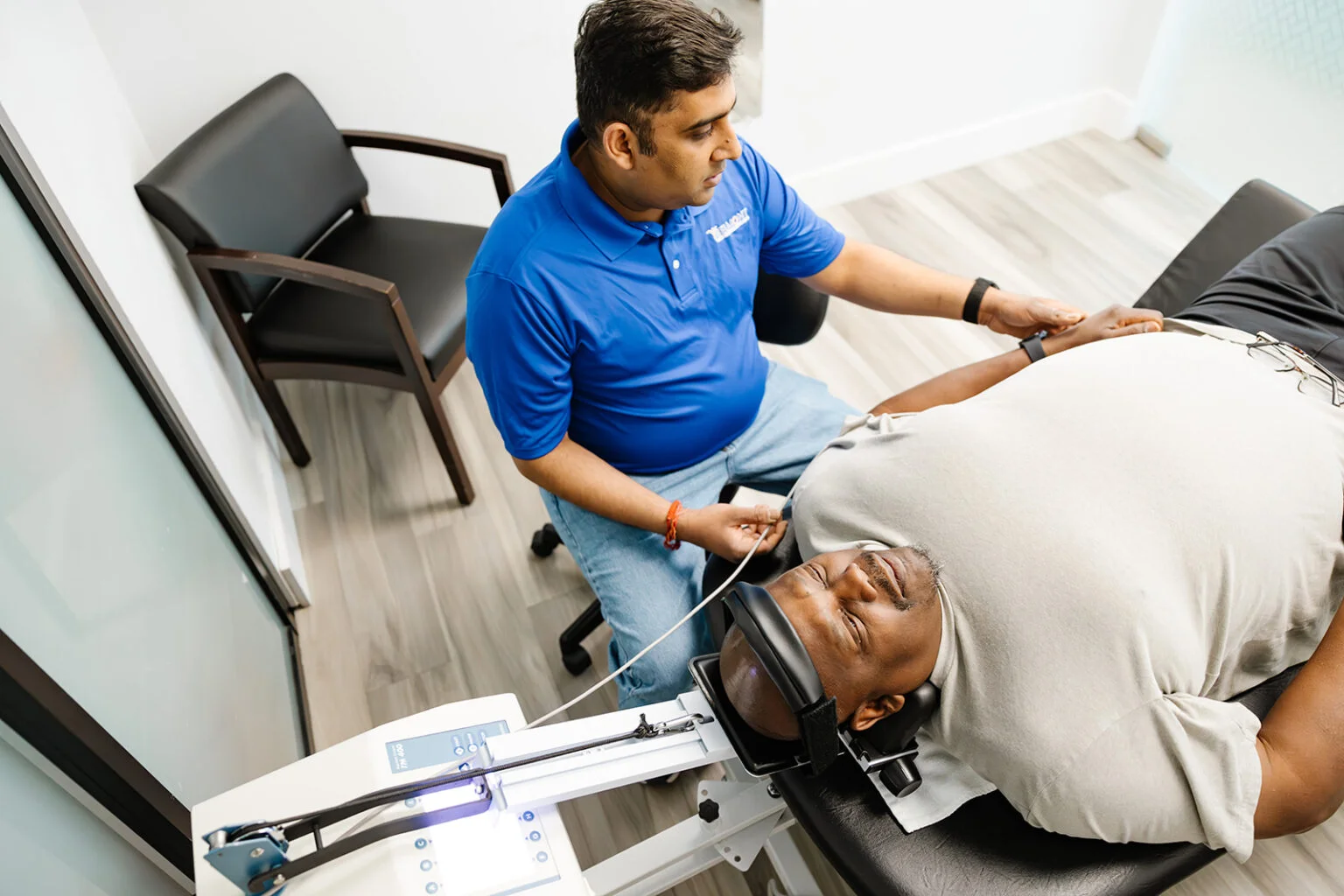 A physiotherapist treating a patient on a spinal decompression and traction table at Belmont Physiotherapy & Health Clinic.